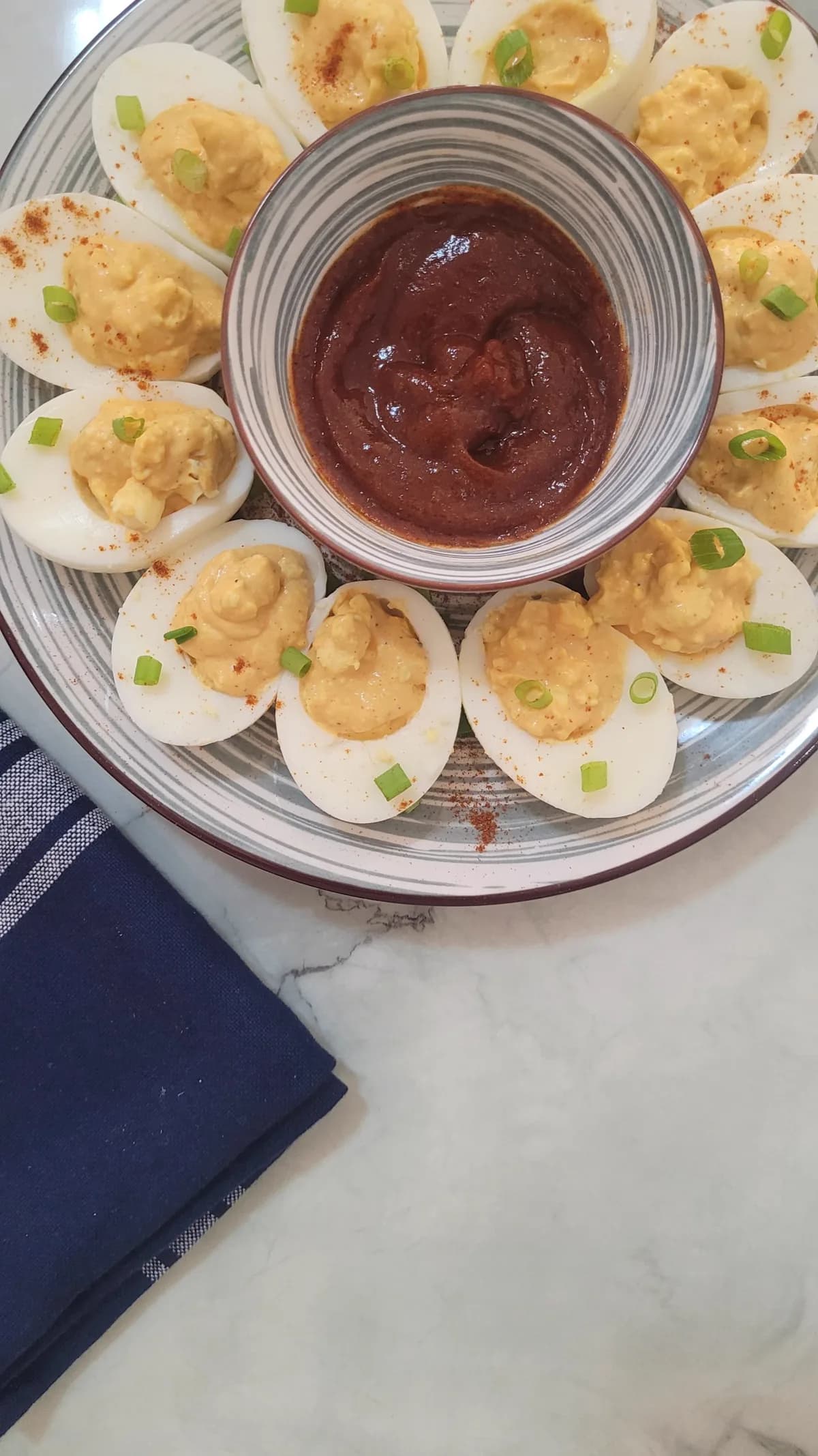 Cooked egg yolks being mixed into a creamy filling