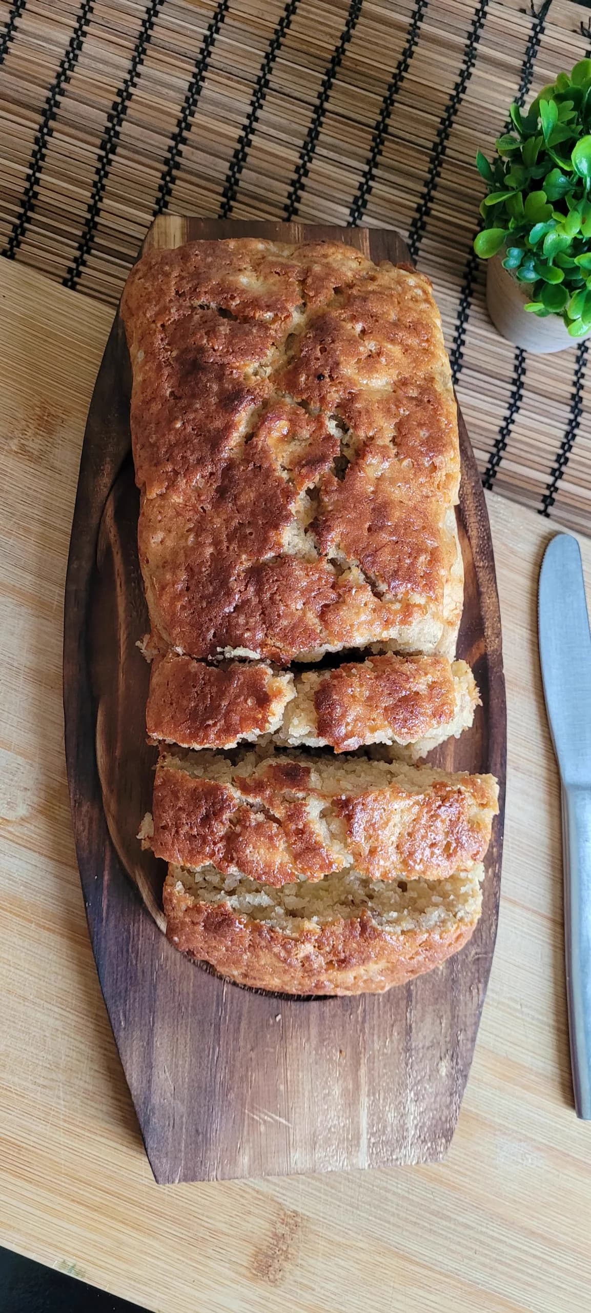A moist homemade banana bread loaf sliced for serving