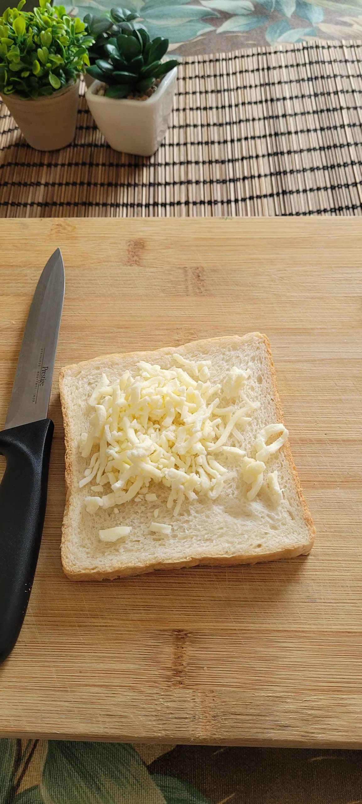 Bread spread with garlic butter and topped with cheese