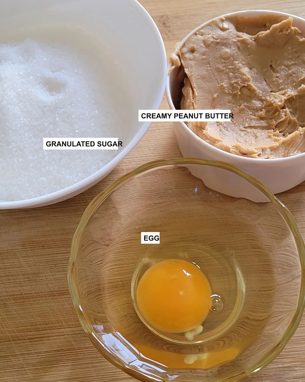 Visible peanut butter cookie ingredients labeled with creamy peanut butter, granulated sugar, and egg