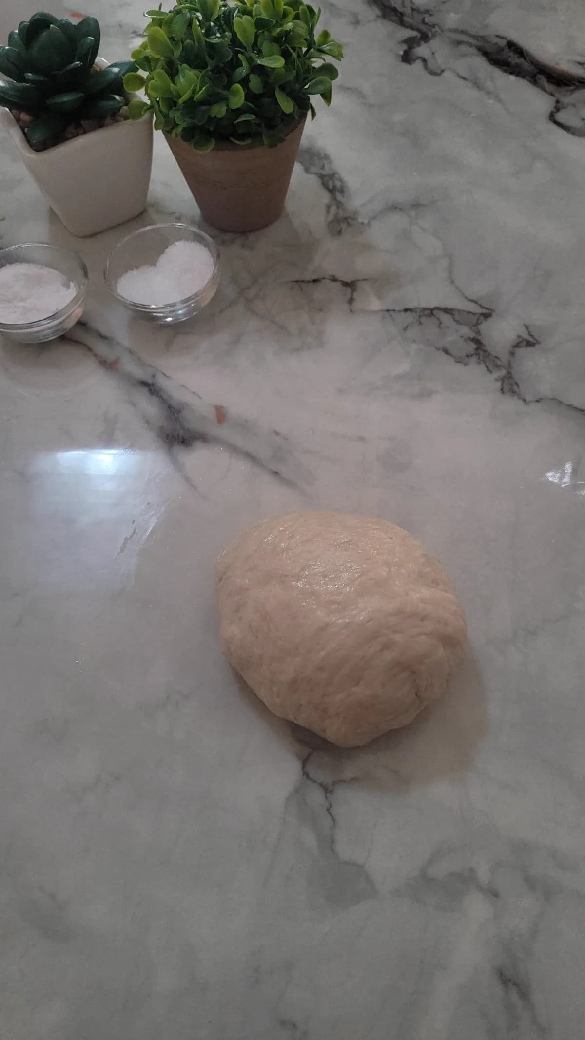 Pretzel dough being cut and prepared for its baking-soda bath